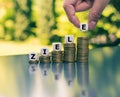 Dice form the German word `Ziele` `goals` in English on increasing high stacks of coins. Royalty Free Stock Photo