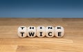 Dice form the words `THINK TWICE`