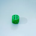 dice green big on a blue background with shadow as a switch.minimal still concept Royalty Free Stock Photo