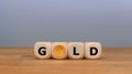 Dice and a Krugerrand coin form the word `GOLD`