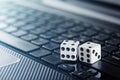 Dice on laptop computer keyboard. ÃÂ¡oncept of online gambling and online casino. Creative idea with devil`s bones and PC keyboard. Royalty Free Stock Photo