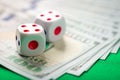 Dice and lots of hundred dollar bills Royalty Free Stock Photo
