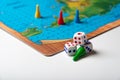Dice with numbers and playing chips near the board game Royalty Free Stock Photo