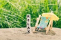 Dice placed next to a beach chair form the word `relax`
