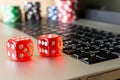 Dice, poker chips on the laptop. The concept of online games. Cl