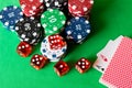 Dice, poker chips and playing cards on the green table . Game co