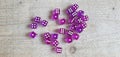 An aerial view of purple dice spread around showing different values Royalty Free Stock Photo