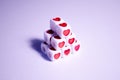 Dice pyramid with hearts. Cubes with hearts and letters. The 14th of February. Hearts on white cubes. Dice beads. Love Royalty Free Stock Photo