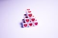 Dice pyramid with hearts. Cubes with hearts and letters. The 14th of February. Hearts on white cubes. Dice beads. Love Royalty Free Stock Photo