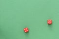 Dice of red color on a green background. Top view, copy space. Gambling concept Royalty Free Stock Photo