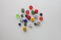 Dice rolled multiple colors on solid background Royalty Free Stock Photo