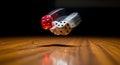 Dice rolling on wooden surface Royalty Free Stock Photo
