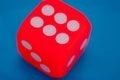 A dice showing six on blue background Royalty Free Stock Photo