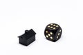 Dice and a small black plastic house Royalty Free Stock Photo