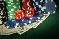 Dice and stacks of chips on a poker table in a club. A successful combination brought a rich win in the game craps Royalty Free Stock Photo