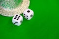 Dice white on green cloth or cloth