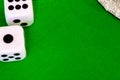 Dice white on green cloth or cloth