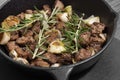 Diced Aberdeen Angus beef with shallots and rosemary, fried in a cast iron frying pan.