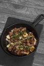 Diced Aberdeen Angus beef with shallots and rosemary, fried in a cast iron frying pan.