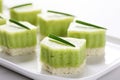 diced avocado over rice cake slices on a white background