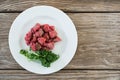 Diced beef and corainder leaves in white plate