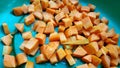 Diced carrots in a container green background