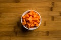 Diced carrots on wooden chopping board Royalty Free Stock Photo