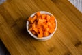 Diced carrots on wooden chopping board Royalty Free Stock Photo