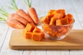 diced carrots on a wooden table, selective focus