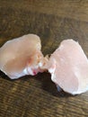 Diced chicken pieces of healthy lean white meat on a cutting board, filleted for cooking Royalty Free Stock Photo