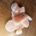 Diced chicken pieces of healthy lean white meat on a cutting board, filleted for cooking