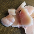 Diced chicken pieces of healthy lean white meat on a cutting board, filleted for cooking