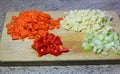 Diced or chopped vegetables on a wooden board. Royalty Free Stock Photo