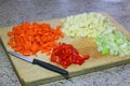 Diced or chopped vegetables on a wooden board. Royalty Free Stock Photo