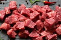 Diced cubed beef meat on stone board
