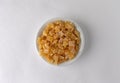 Diced dried peaches in a bowl on a white background Royalty Free Stock Photo