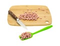 Diced ham on cutting board and green spoon