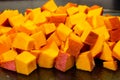 Diced pieces of pumpkin cut up and prepared for soup Royalty Free Stock Photo