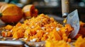 Diced pumpkin with seeds and rosemary on wooden cutting board