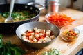 diced tofu frying in oil with colorful bell peppers Royalty Free Stock Photo