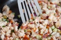 Diced vegetables and meat of a diet turkey in a frying pan Cooking at home close-up. Roasting poultry meat with peppers, cucumbers Royalty Free Stock Photo