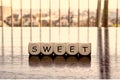 5 dices forming the Word `sweet`