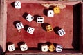 Dices in an old red velvet box. Lucky number and golden dice. Game of chances.