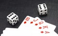 Dices and playing cards on a black background Royalty Free Stock Photo