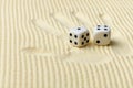 Dices on sand surface and palm print Royalty Free Stock Photo