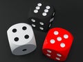 Dices in various colors on black background Royalty Free Stock Photo