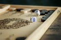 Dices on the wooden board of backgammon game. Backgammon table game for two persons. Slow living, stop rushing Royalty Free Stock Photo