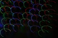 Dichroic light waves of multicolored party lights traveling in space