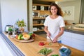 Dicing up a healthy meal. an attractive young woman chopping vegetables in a kitchen. Royalty Free Stock Photo