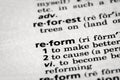 Dictionary definition of the word reform in focus.